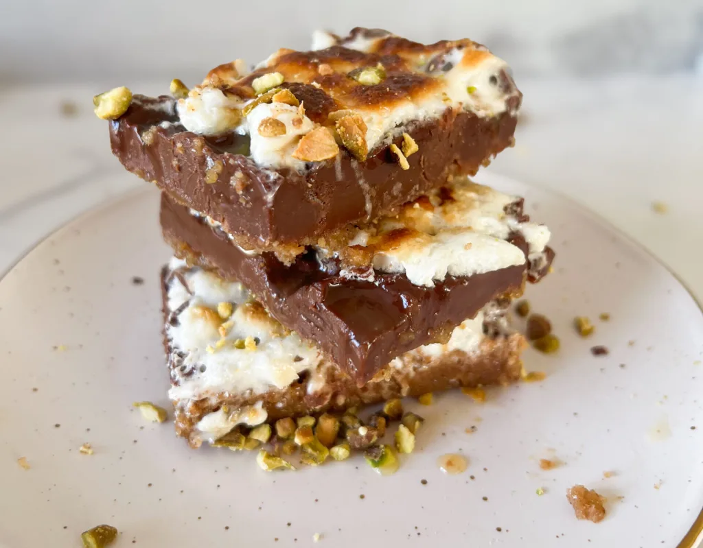 Stack of gulab jamun s’mores bars showing graham, chocolate and marshmallow layers